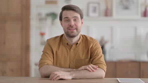 Young Man doing Video Call on while Sitting in Office