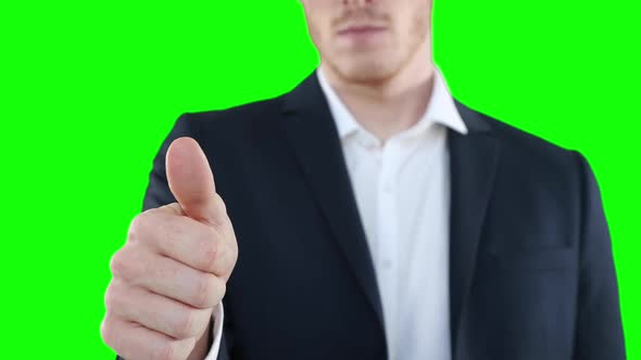 Mid section of a Caucasian man thumbs up on green background