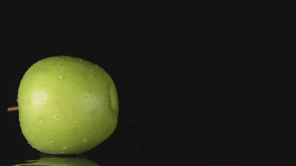 Green Apple Rolls On A Black Background And Stands