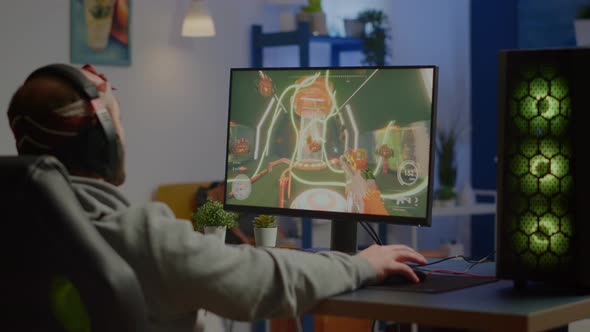 Game Over for Sad Gamer Playing Shooter Video Games on Powerful Computer alt