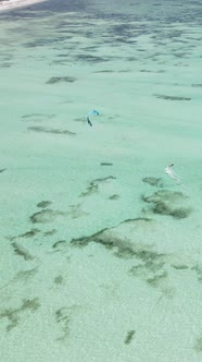 Vertical Video Kitesurfing Near the Shore of Zanzibar Tanzania alt