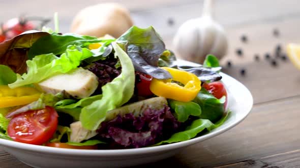 Colorful fresh homemade healthy salad with boiled chicken breast