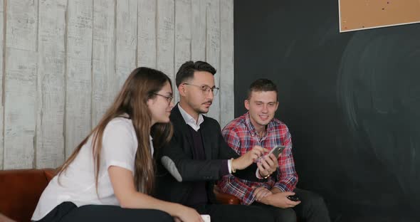 Businessman Giving a Presentation to Colleagues in the Office on the Phone alt