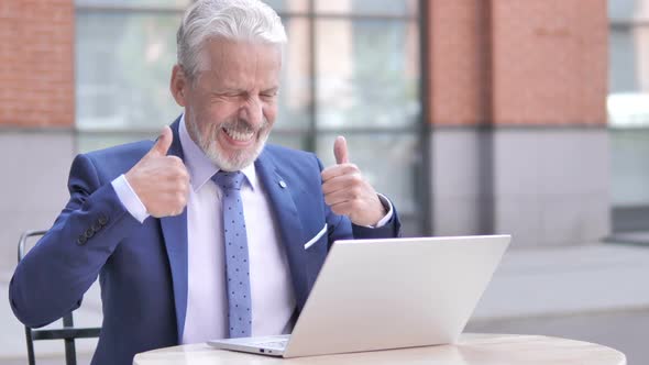 Old Businessman Celebrating Success on Laptop Outdoor alt