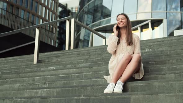 Sitting on Stairs Talking on Phone alt