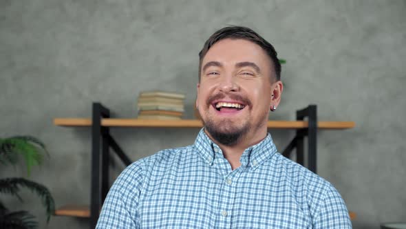 Close up laughing businessman CEO standing in office turns head looking camera alt