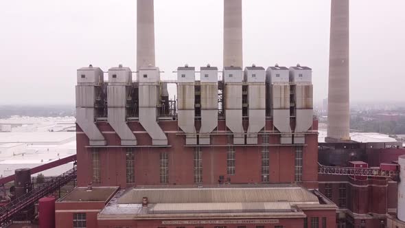 Otto C. Eckert Municipal Power Plant With Tall Smoke Stack In Lansing, Michigan. - Tilt-Up Shot alt