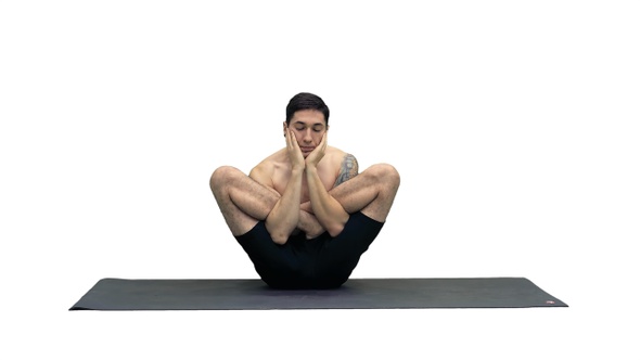 Muscular handsome young man working out yoga, lotus, hands alt