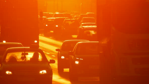 Urban street cars traffic city sun road sunset. Sunrise cars slow motion. Silhouette city cars sun