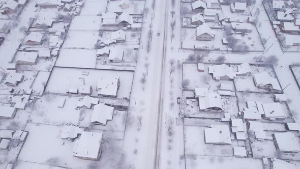 Aerial view of the snow village with private houses and garden plots at winter alt