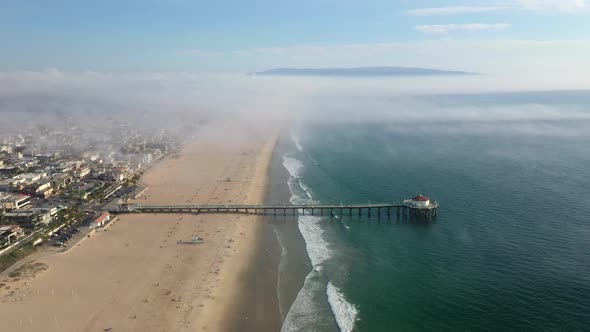 Manhattan Beach Pier On A Misty Day In California, United States - aerial pullback alt