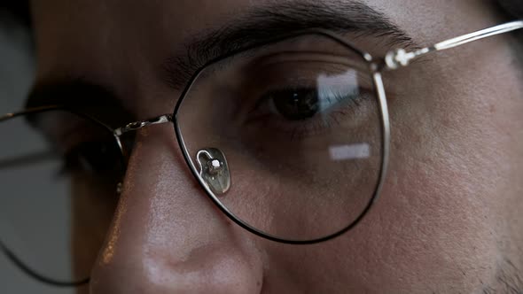 Close-Up Of a man with Glasses Using a Computer, Watching news or Movies Online alt