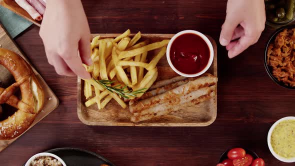 Putting Tray with Smoked Sasuages and Fried Potatoes Top View Pickled Cucumbers Bratwursts and Fresh alt