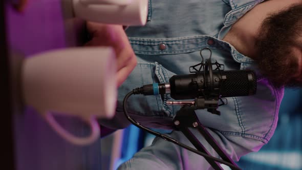 Closeup of Online Radio Station Host Recording Podcast Interview with Guest in Online Talk Show alt