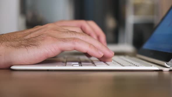 Closeup Hands Typing on the Computer Laptop Keyboard