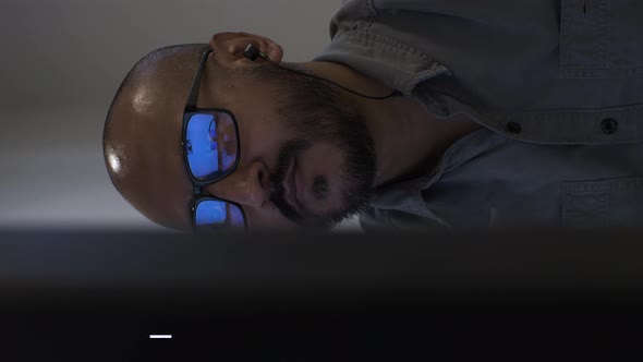 Ethnic Minority Office Male Wearing Glasses Browsing On Computer. Vertical Video, Locked Off, Viewed alt