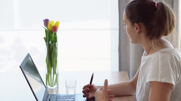 Authentic Caucasian Young Woman Chatting On Laptop At Home In Living Room alt