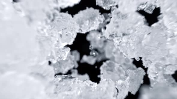 Super Slow Motion Shot of Falling Crushed Ice on Black Background at 1000Fps alt
