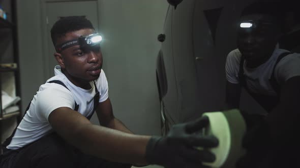 An AfricanAmerican Service Worker Applies a Protective Layer of Leoceramics alt