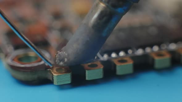 Soldering ESC Contacts. Extreme Close Up of Young Man's Hands Assembling FPV Racing Drone.