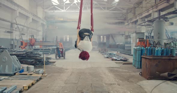 Redhead Woman Is Doing Aerial Gymnastics and Then Walks Off Gas Mask alt