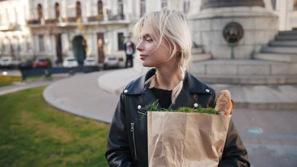 Portrait of Young Cheerful Women Holding Paper Bag of Groceries From Supermarket Outdoors in Old alt