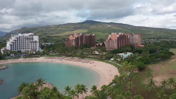 Push-in aerial shot of luxury resorts with coastal lagoon in Ko'Olina, Hawaii. 4K alt