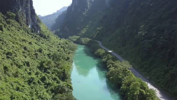Camera Moves Over River and Highway To Sunlight Spot on Road alt