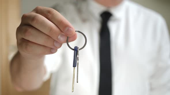 Businessman Holds in Hand Keys for Residential House