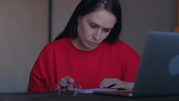 Upset Girl Pull Out a Sheet with Writed Ideas From a Notebook alt