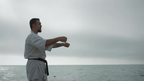 Bearded Sportsman Practicing Martial Arts Standing Beach alt