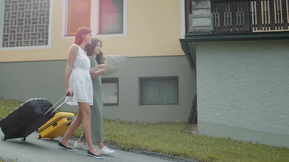 Travelers with Suitcases Using Paper Map alt