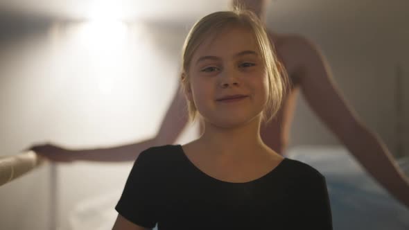 Portrait of Confident Smiling Inspired Caucasian Girl Looking at Camera Standing in Backlit Fog with alt