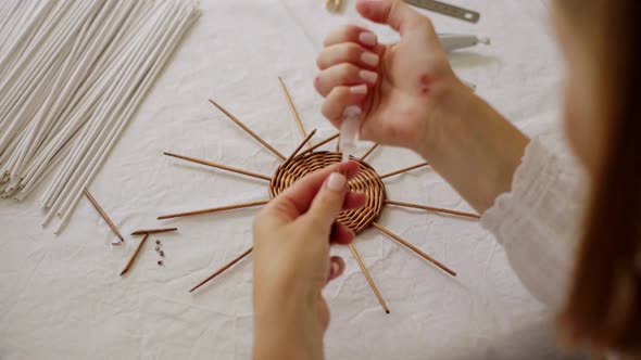 Mature Woman Making Paper Vine Basket at Home alt
