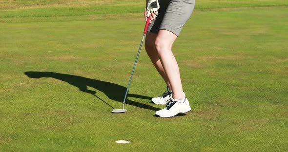 Female golf player playing golf alt