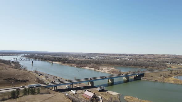 landscape view of bridges overrider in North Dakota. Blue sky with city in the background.