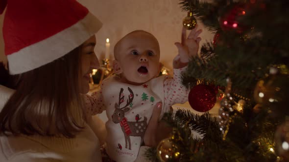 Mom Shows Her Child a Christmas Tree