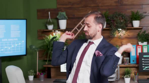 Handheld Shot of Office Worker Dancing alt