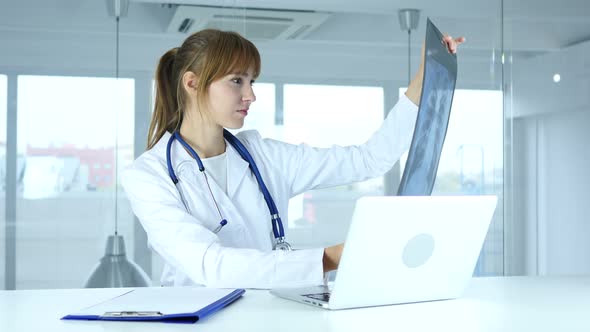 Female  Doctor Examining X-ray of Patient alt
