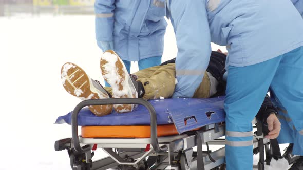 Paramedics Putting Patient on Stretcher alt