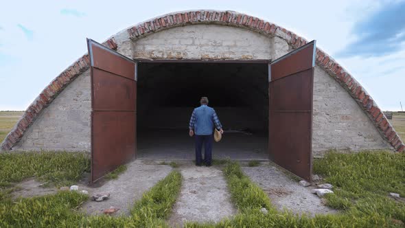 Desperate farmer near an empty barn.  World economic crisis alt