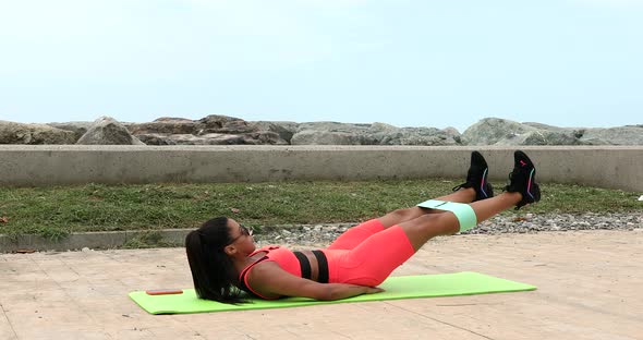 Active fitness young woman working out abdominals.