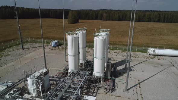 The Drone Rises Above the Storage Tanks for Gaseous Substances