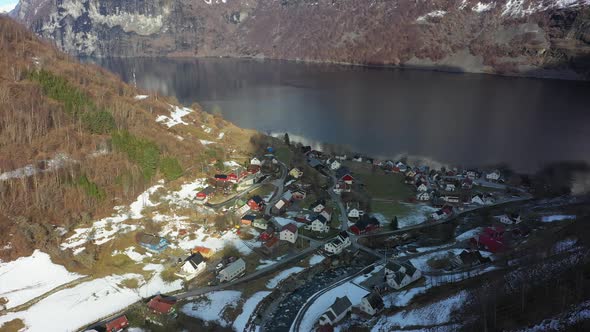 Distant aerial overview of Undredal village by the aurlandsfjord - Sunny winter aerial during sunris alt