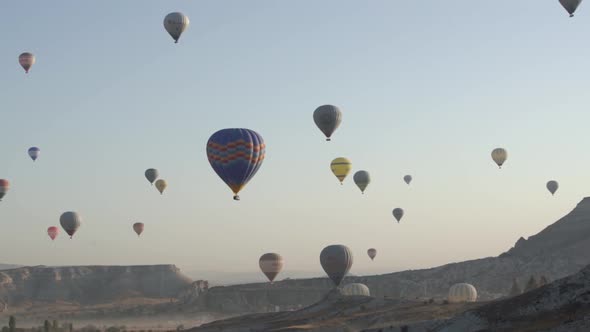 Different Colourful Hot Air Balloons Fly Over Mountains