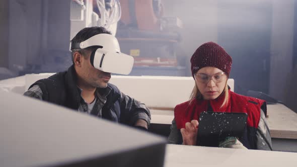 Male and Female Artisans with Gadgets Discussing Work alt