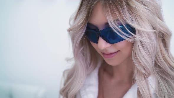 Happy Woman in Glasses Undergoes Laser Epilation in Clinic alt