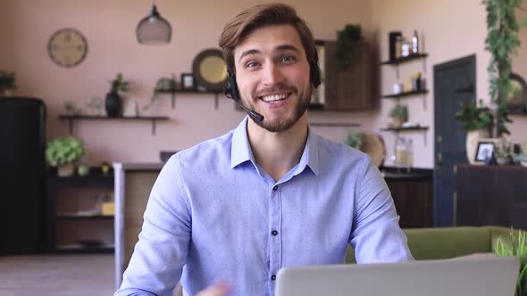 Confident man wearing headset speaking and watching business webinar training, listening to lecture. alt