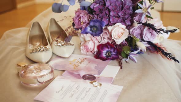 Medium Shot Wedding Accessories of the Bride Slow Motion Wedding Bouquet Bride's Shoes Wedding Rings alt