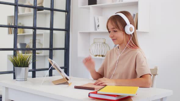 Teenage Girl Studying Online From Home with Distance Teacher